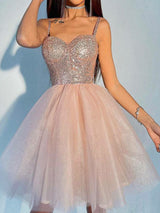 woman in a short pink sequin and tulle party dress