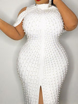 Close-up of a white pearl-embellished sheath dress showing intricate beadwork and silhouette