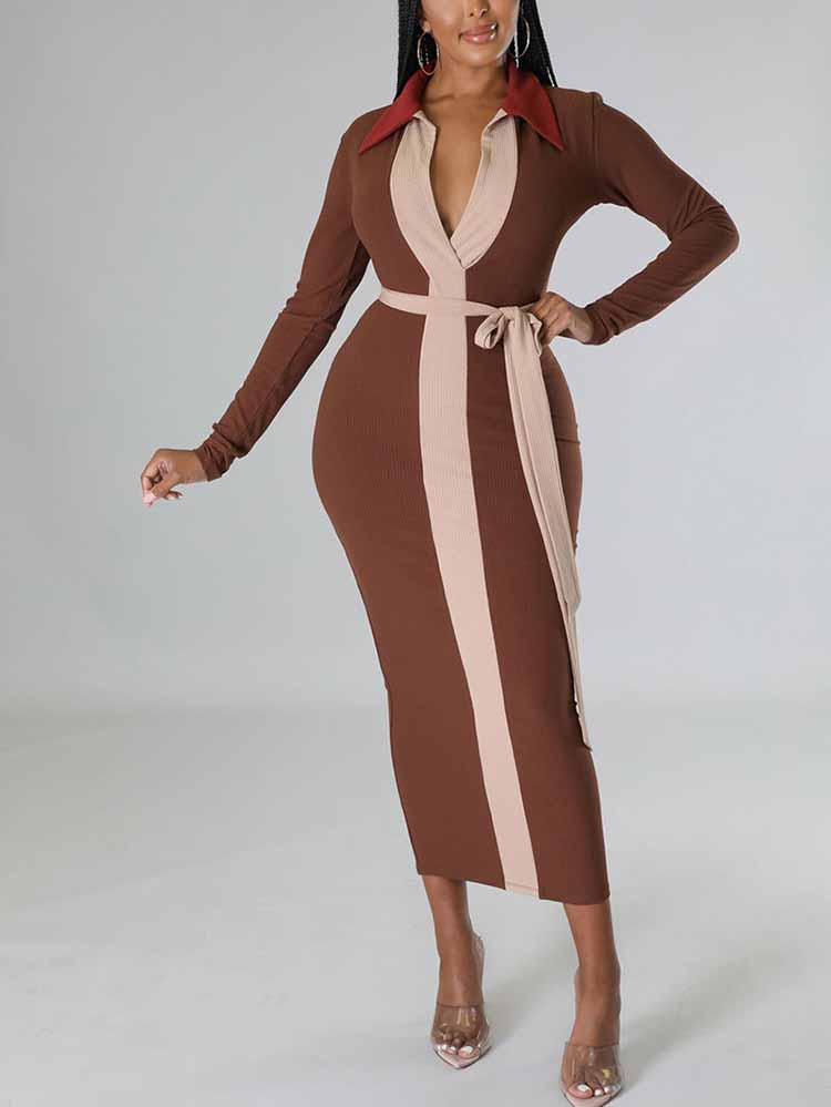 Woman wearing a long-sleeved brown ribbed midi dress with contrasting beige panels and a matching waist tie.