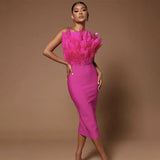 Model wearing a hot pink strapless bodycon dress with feather embellishment on the bust