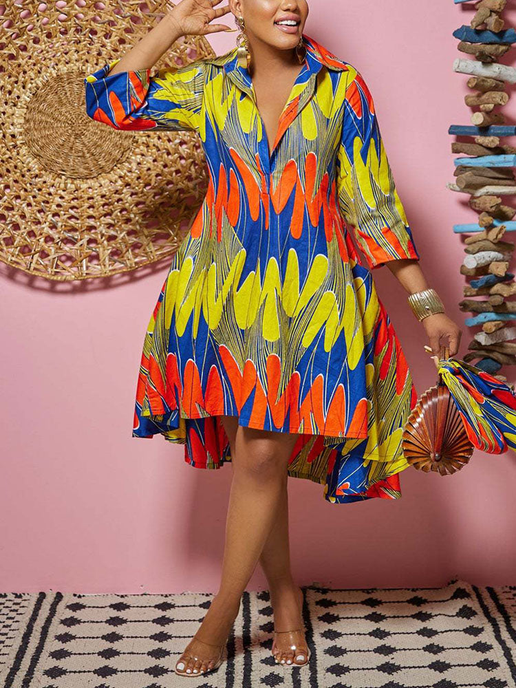 Woman showing the side of a colorful printed high-low dress with 3/4 sleeves and pockets.