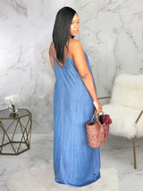 Back view of a woman in a blue denim maxi dress