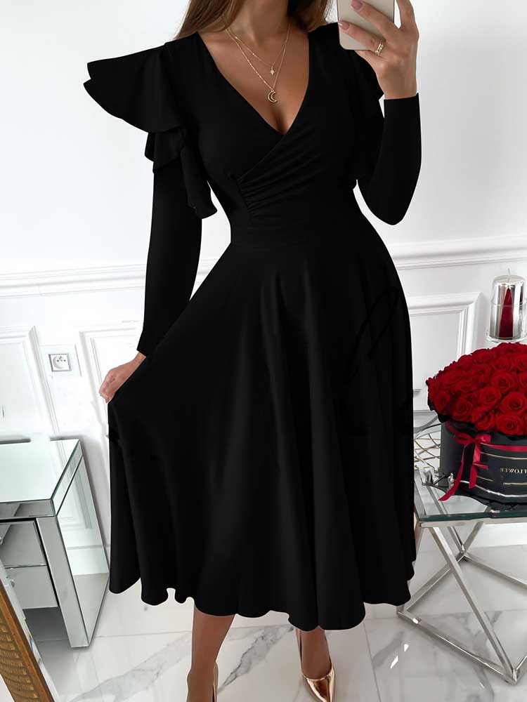woman wearing a black V-neck dress with ruffled long sleeves and a flared skirt