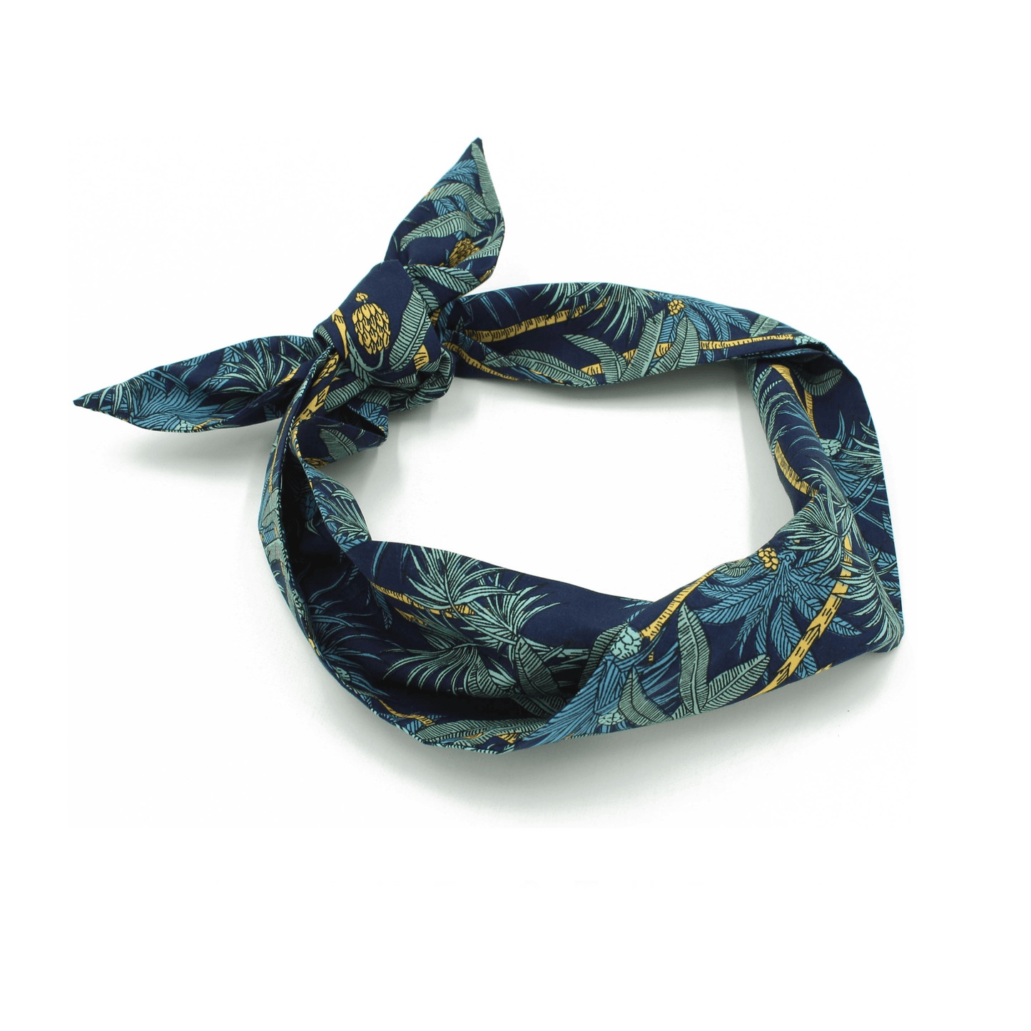 Close-up of a navy blue headband with a tropical print, featuring a knot.