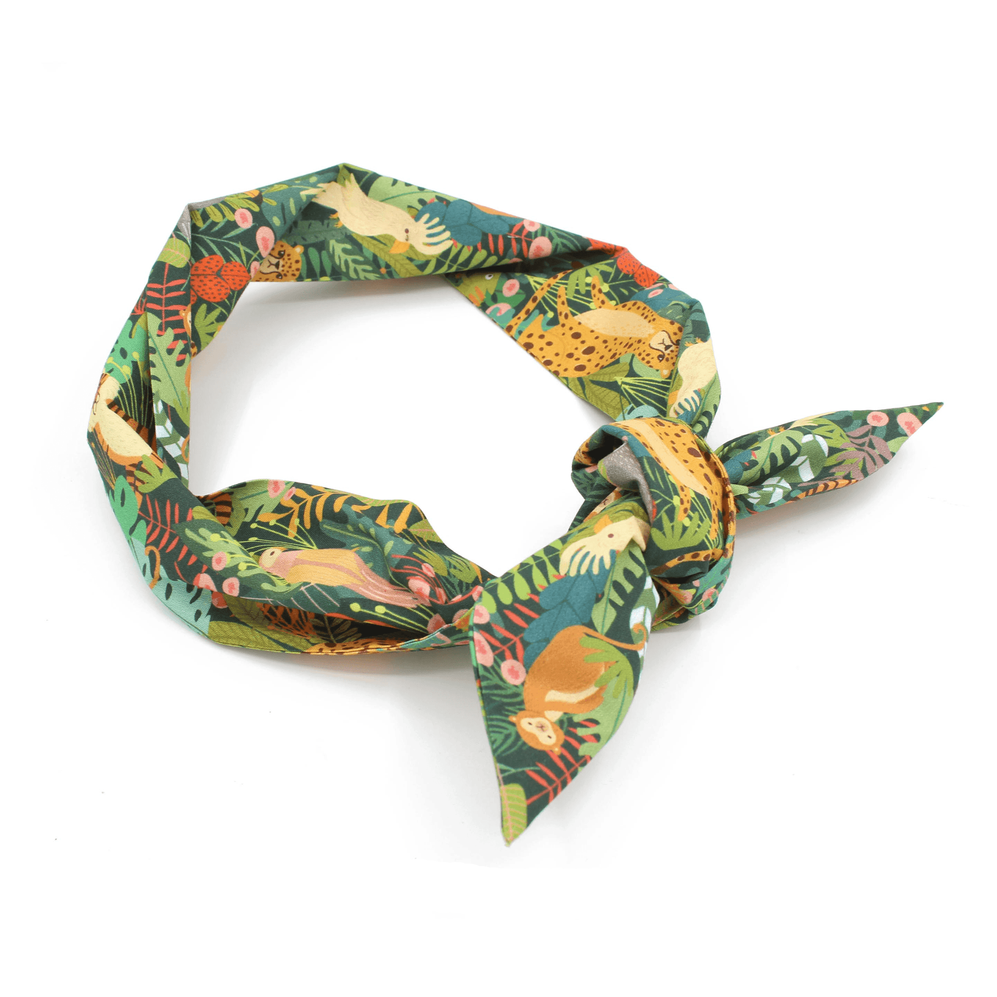 A green jungle print headband tied in a knot, viewed from the side.