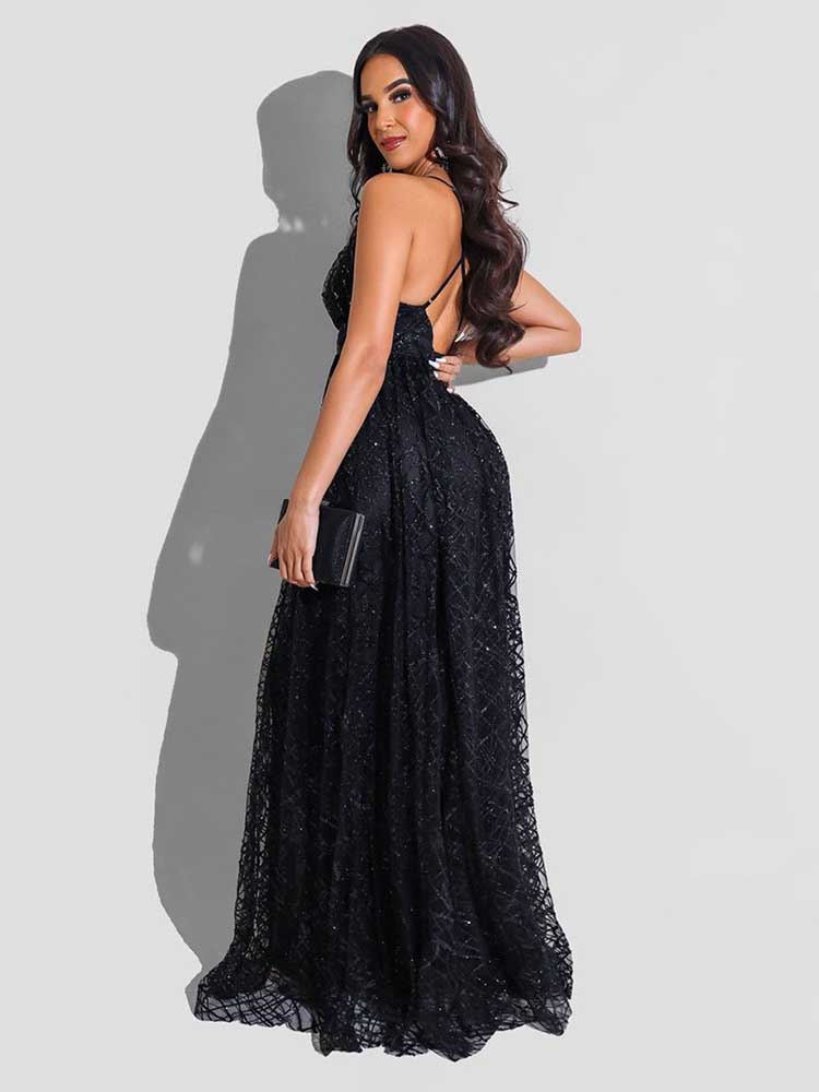 Woman in a black floor-length gown with spaghetti straps and a deep V-neckline, shown from the back.