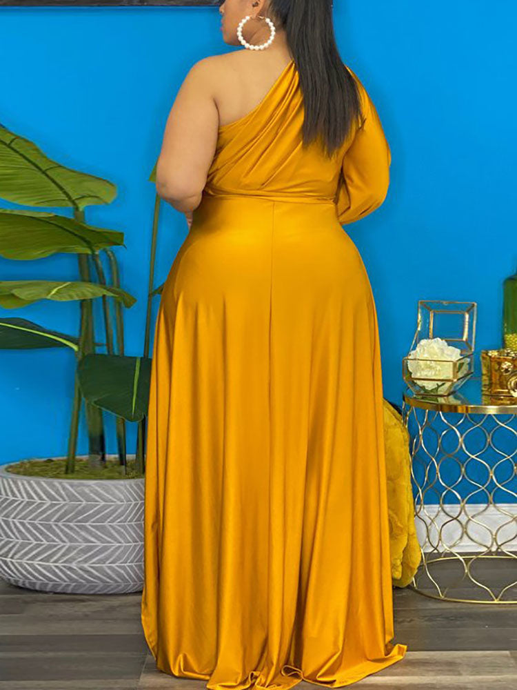 Back view of a woman wearing a mustard yellow one-shoulder high-low maxi dress.