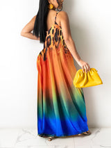 Back view of a woman wearing a leopard print and gradient maxi dress with spaghetti straps.