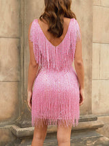 Woman wearing a pink sequined dress with fringe detailing, back view