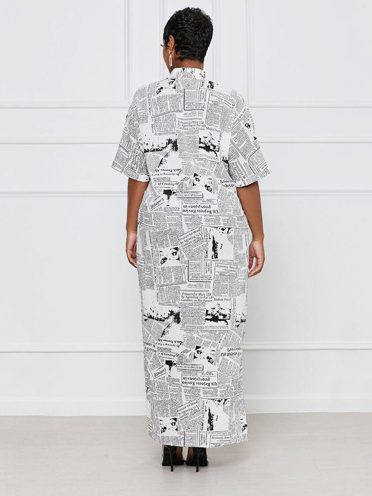 Back view of a woman wearing a white and black newspaper print maxi dress with short sleeves.