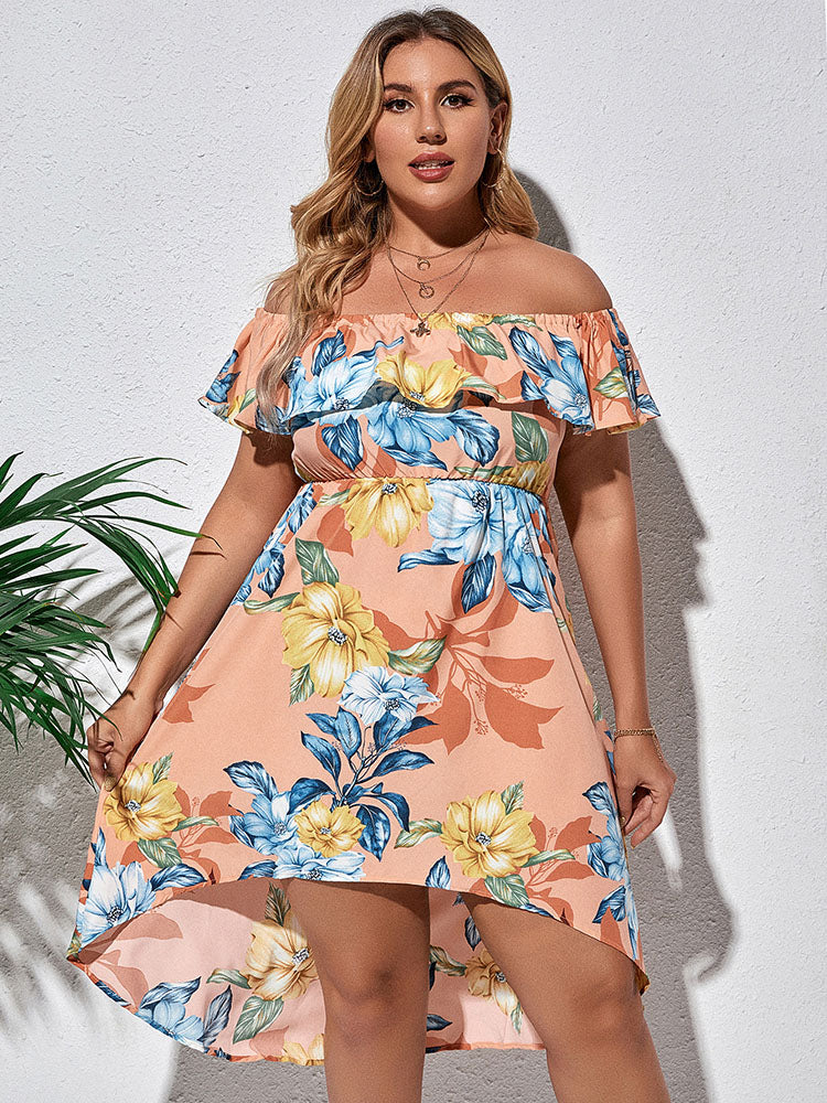 Close-up of a woman wearing a peach floral print off-the-shoulder dress, showing the ruffled neckline and elasticated waist.