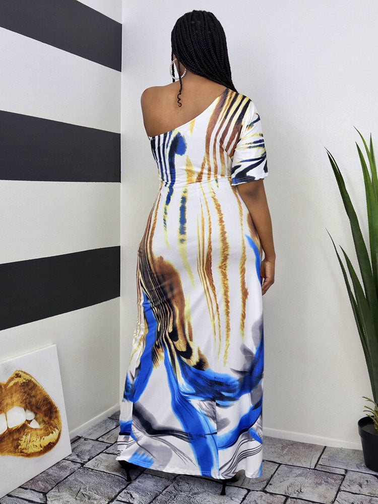 Back view of a woman wearing a one-shoulder maxi dress with an abstract print.
