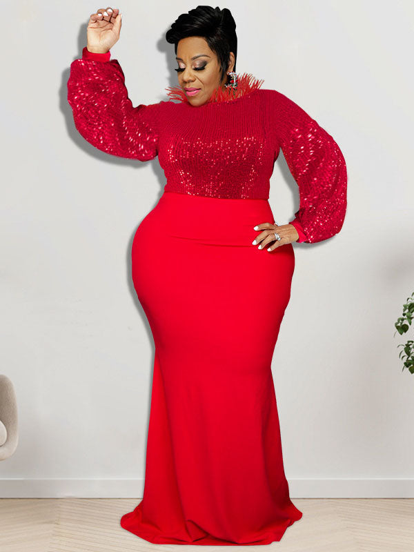 Woman wearing a red sequined top with long sleeves and a red floor-length skirt, adorned with red feather trim around the neckline, posing with one arm raised.