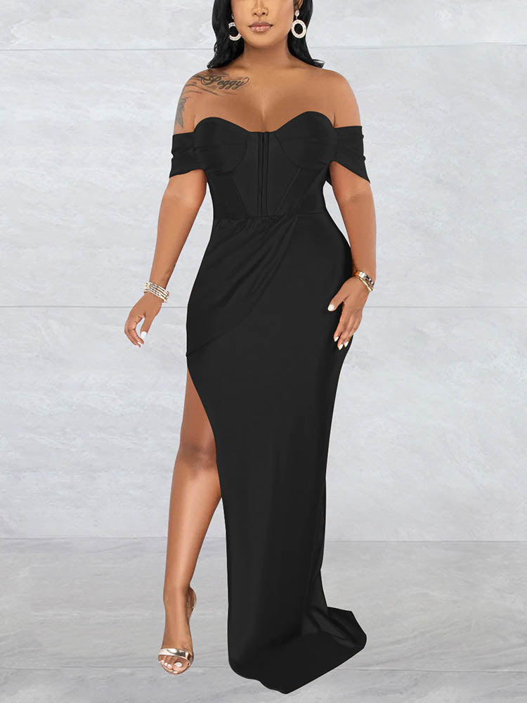 Woman wearing a floor-length black off-the-shoulder dress with a high slit