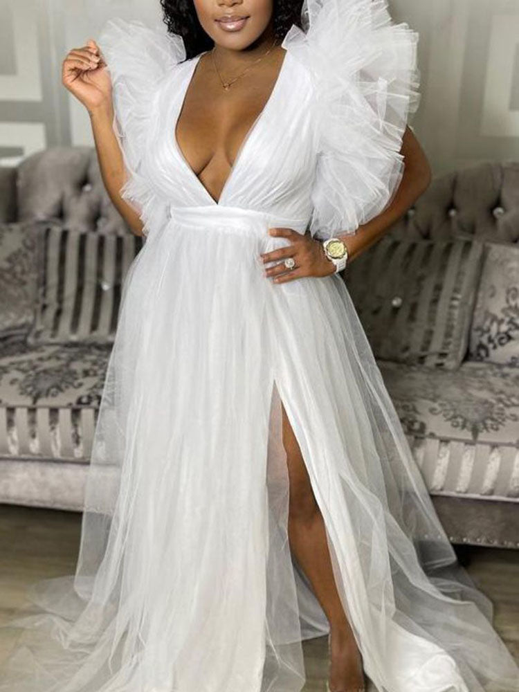 elegant white gown with a high slit and intricate ruffled shoulder detailing