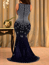 Back view of a woman in a black sequined mermaid gown, showcasing the train and fitted silhouette.