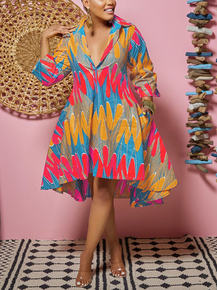 Woman wearing a vibrant printed high-low dress with 3/4 sleeves and pockets.
