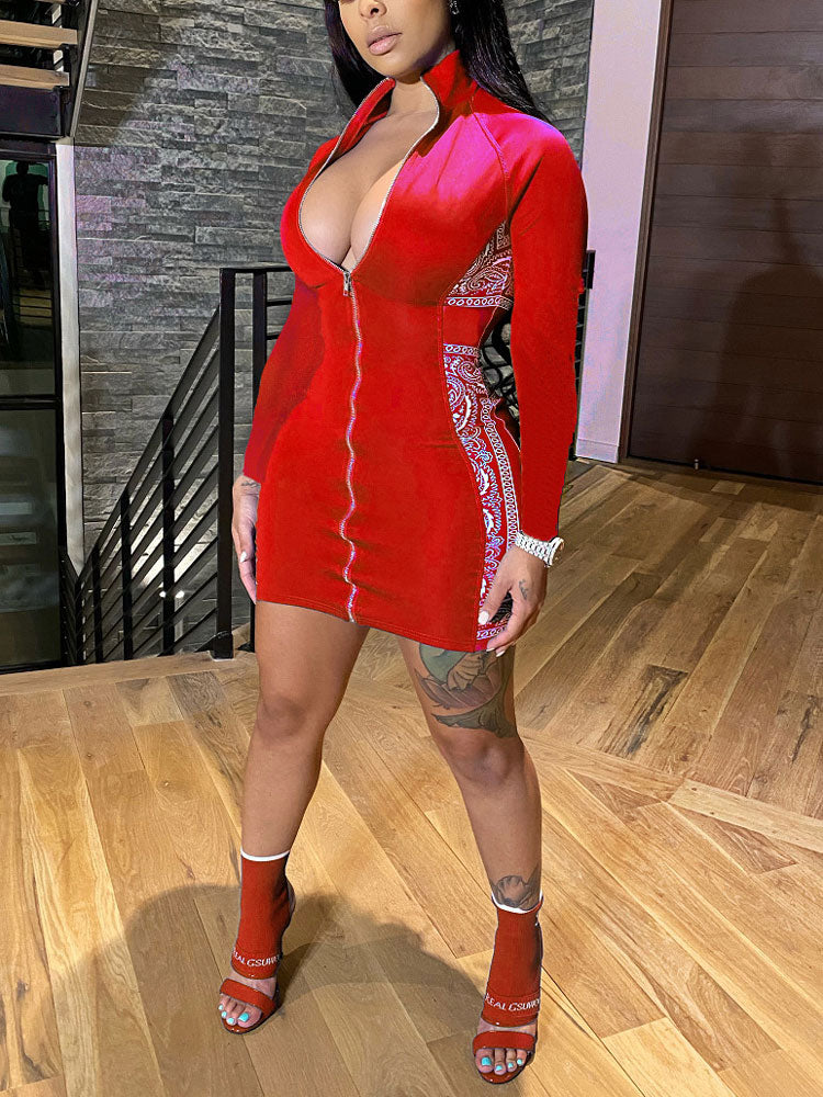 Woman wearing a red long-sleeved bodycon dress with a zipper closure and contrasting side panels, standing on wooden stairs.