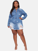 Full-body shot of a plus-size model in a distressed denim mini dress with paint splatter, showcasing the fit and style.