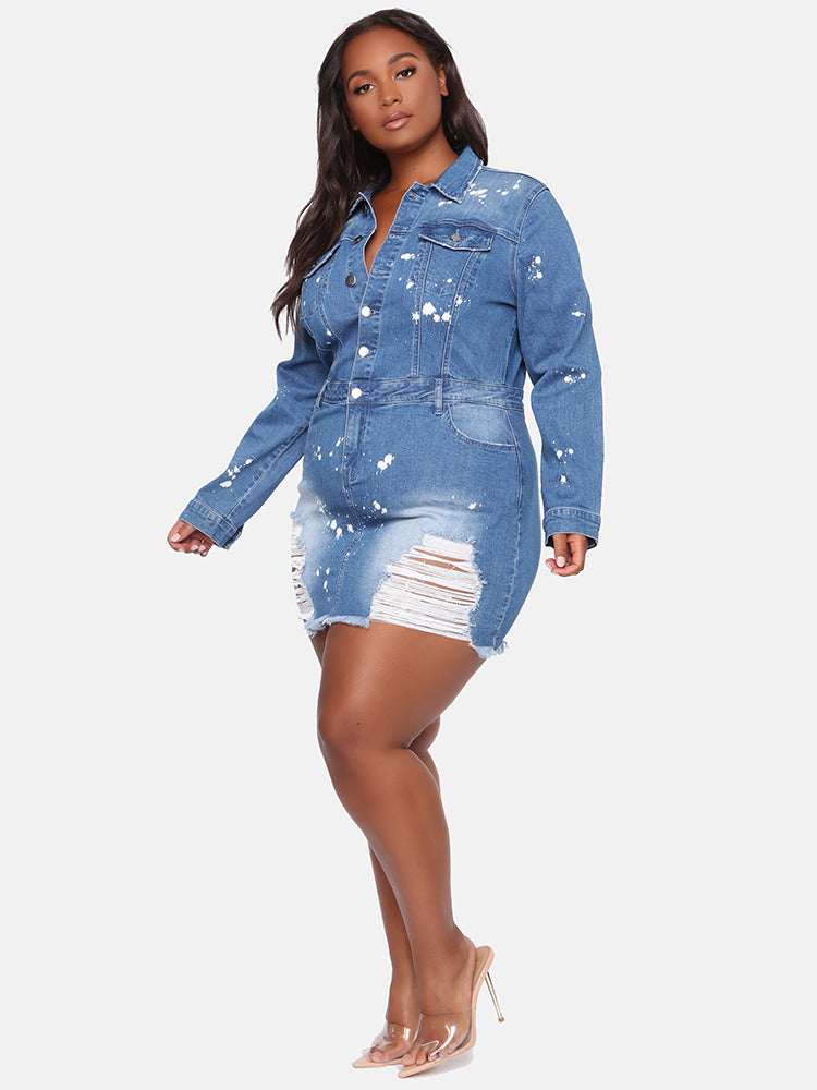 Side profile of a plus-size model in a distressed denim mini dress with white paint splatter, highlighting the silhouette.
