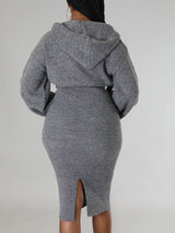 Woman wearing a grey hooded knit sweater and pencil skirt set, back view.