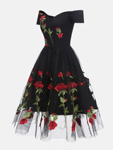 black off-the-shoulder midi dress with embroidered red roses and tulle skirt, side view
