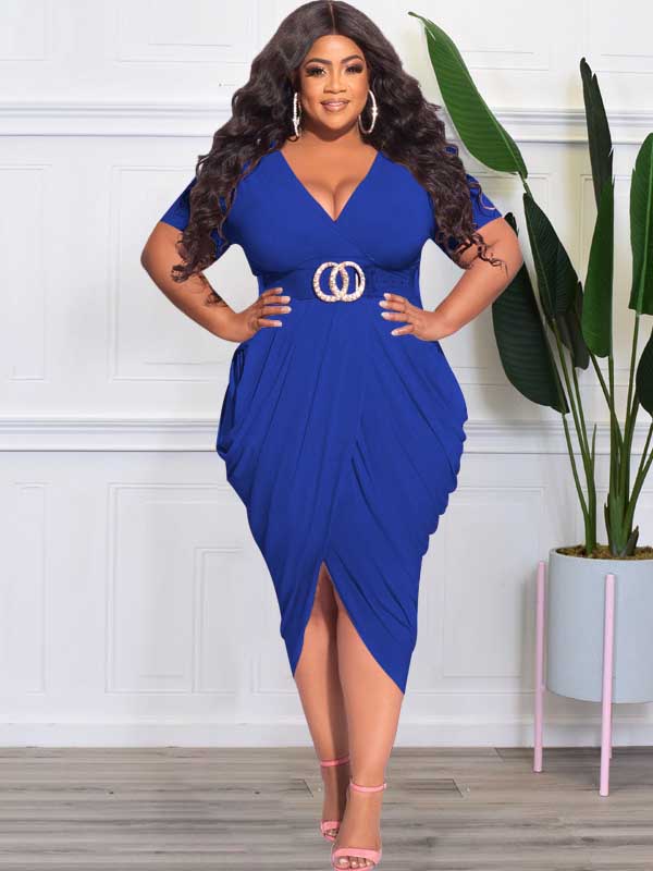 Plus-size model in a royal blue ruched V-neck short-sleeve dress with a tulip hem and side slit, accessorized with a gold double-ring belt and hoop earrings.