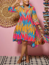 Woman holding a matching printed bag with a colorful printed high-low dress.