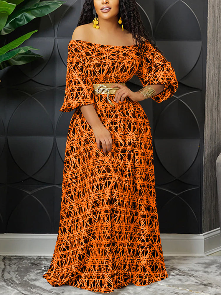 Woman wearing an orange off-the-shoulder maxi dress with a geometric print and a gold belt.