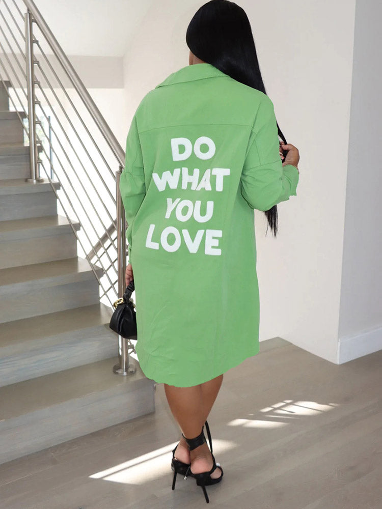Back view of a woman wearing a lime green long-sleeve button-down shirt dress with 'DO WHAT YOU LOVE' graphic print.
