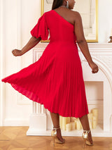 Back view of a woman in a red one-shoulder pleated midi dress twirling.