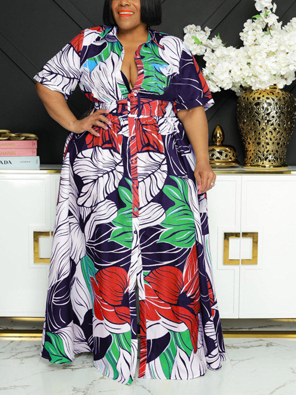 Woman wearing a floral print maxi dress with short sleeves and a belted waist.