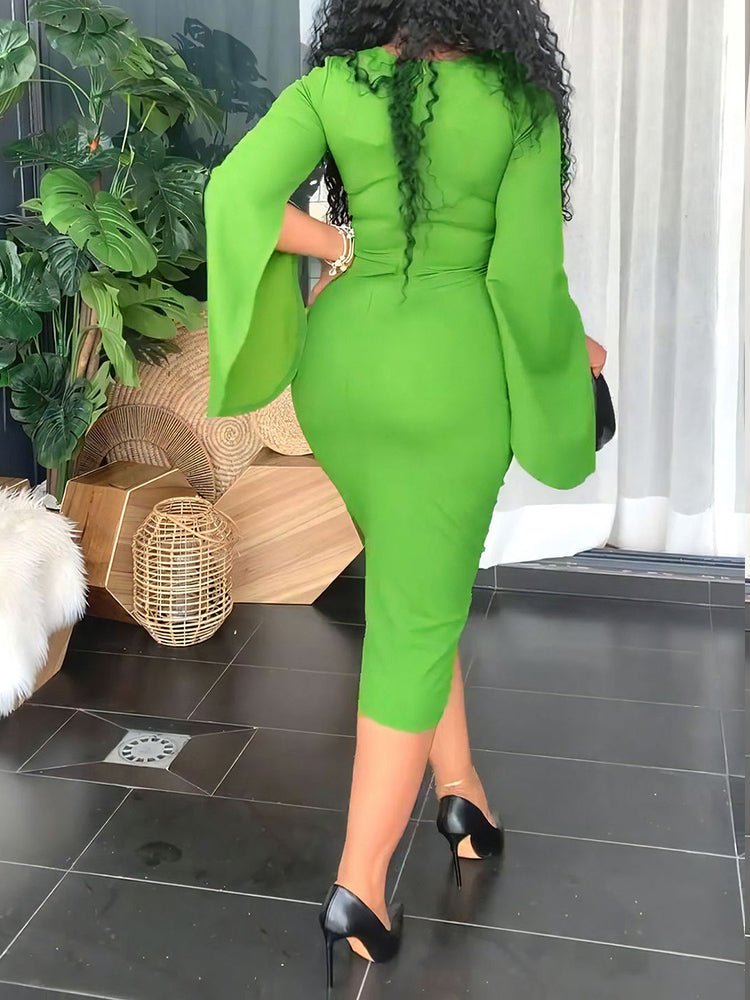 Back view of a woman in a lime green sheath dress with cape sleeves.