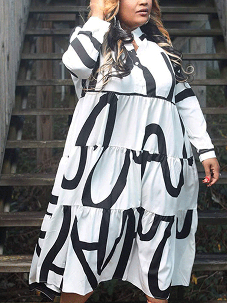A woman wearing a white midi dress with a bold black graphic print and orange peep-toe boots, standing on wooden stairs, full body shot.