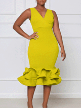 woman wearing a bright yellow sleeveless v-neck dress with a ruffled mermaid hem