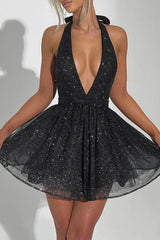 woman wearing a black sparkly halter dress with a deep v-neck and flared skirt