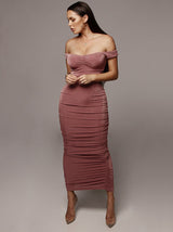 Woman wearing a pink off-the-shoulder ruched sheath dress