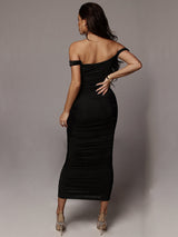 Back view of a woman in a black off-the-shoulder ruched sheath dress