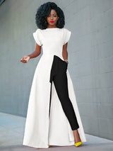 Woman wearing a white high-low maxi dress with black pants and yellow heels