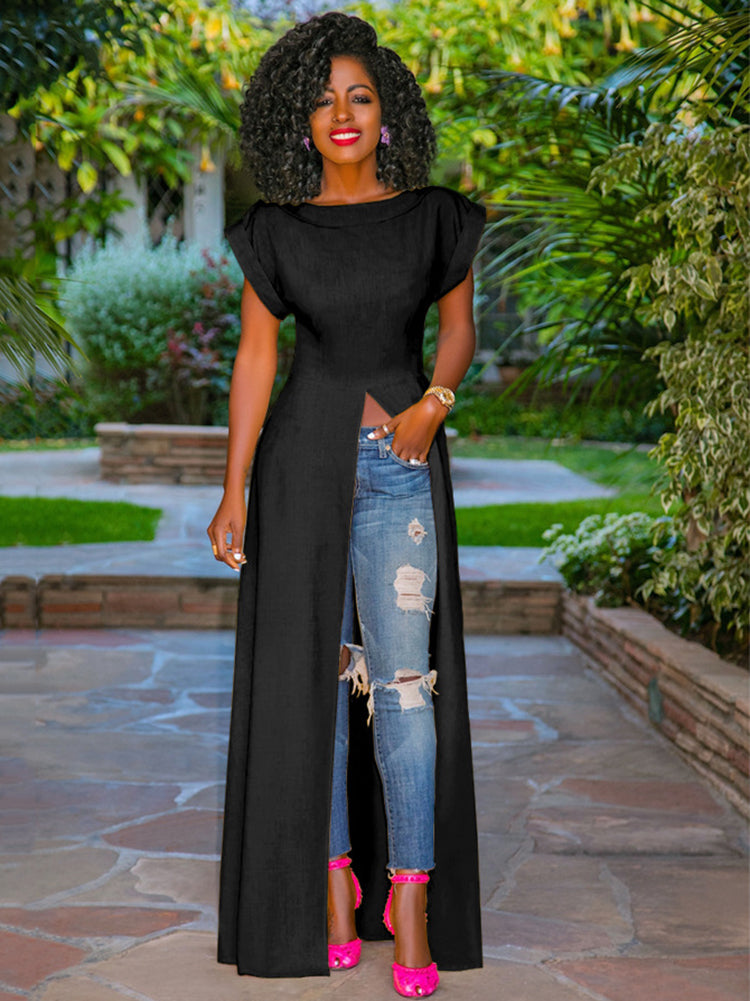 Woman wearing a black high-low maxi dress with ripped blue jeans and pink heels