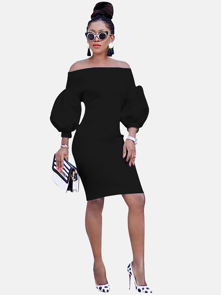 Woman wearing a black off-the-shoulder dress with puff sleeves
