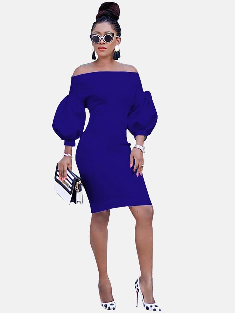 Woman wearing a royal blue off-the-shoulder dress with puff sleeves