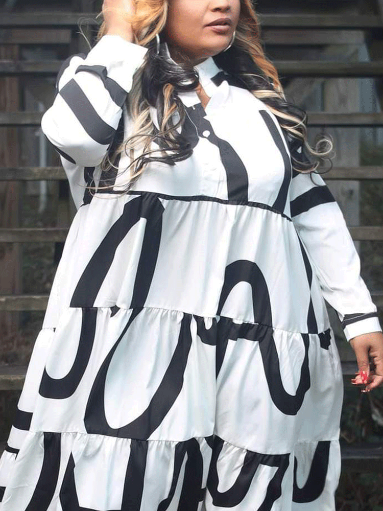 Close-up of a woman wearing a white midi dress with a bold black graphic print, showing the fabric and print detail.