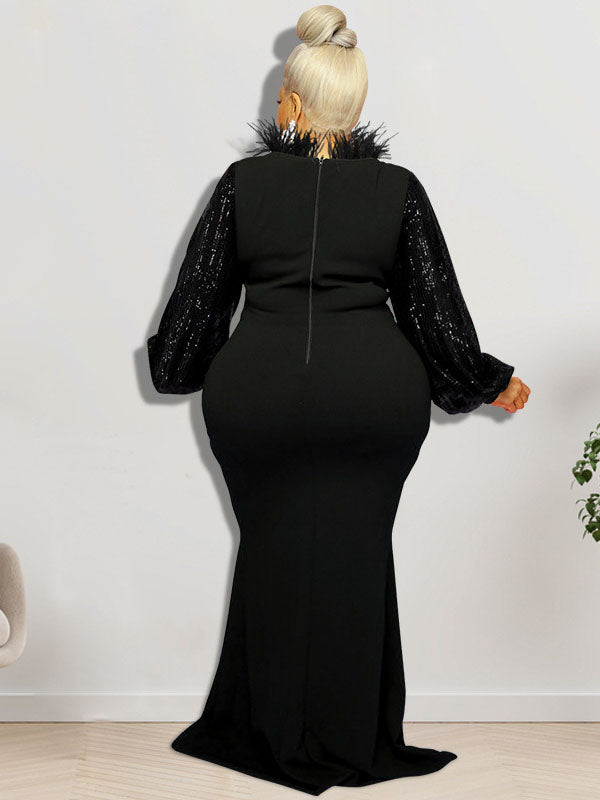 Back view of a woman wearing a black sequined top with long sleeves and a black floor-length mermaid skirt, featuring black feather trim around the neckline.