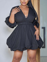 Woman wearing a black V-neck puffed sleeve mini dress with a bubble hem.
