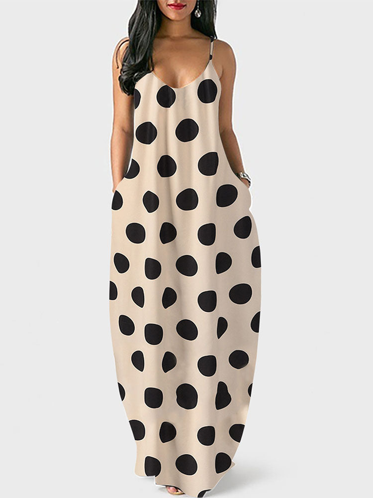 Woman wearing a beige polka dot maxi dress with spaghetti straps and pockets, front view