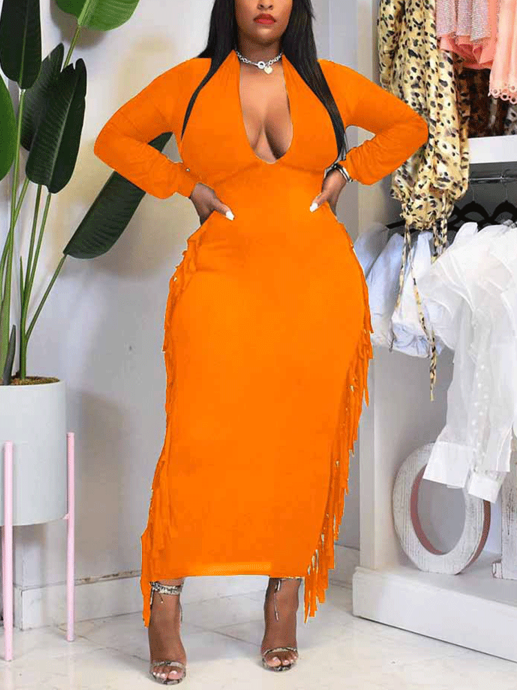 woman wearing an orange long-sleeved bodycon maxi dress with fringe trim and a plunging neckline