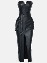 front view of a black faux leather strapless sheath dress with a belt and slit