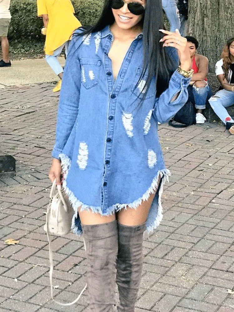 Woman wearing a distressed denim shirt dress with raw hem and grey knee-high boots