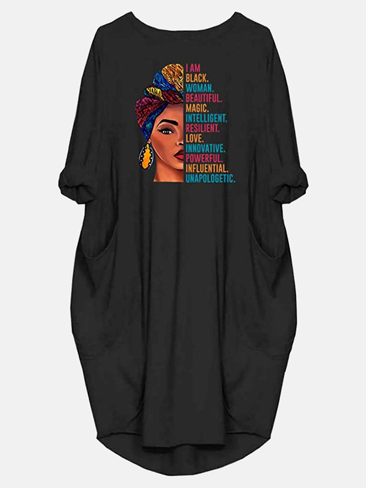 Black t-shirt dress with a graphic print of a woman and empowering text, showing the front of the garment.